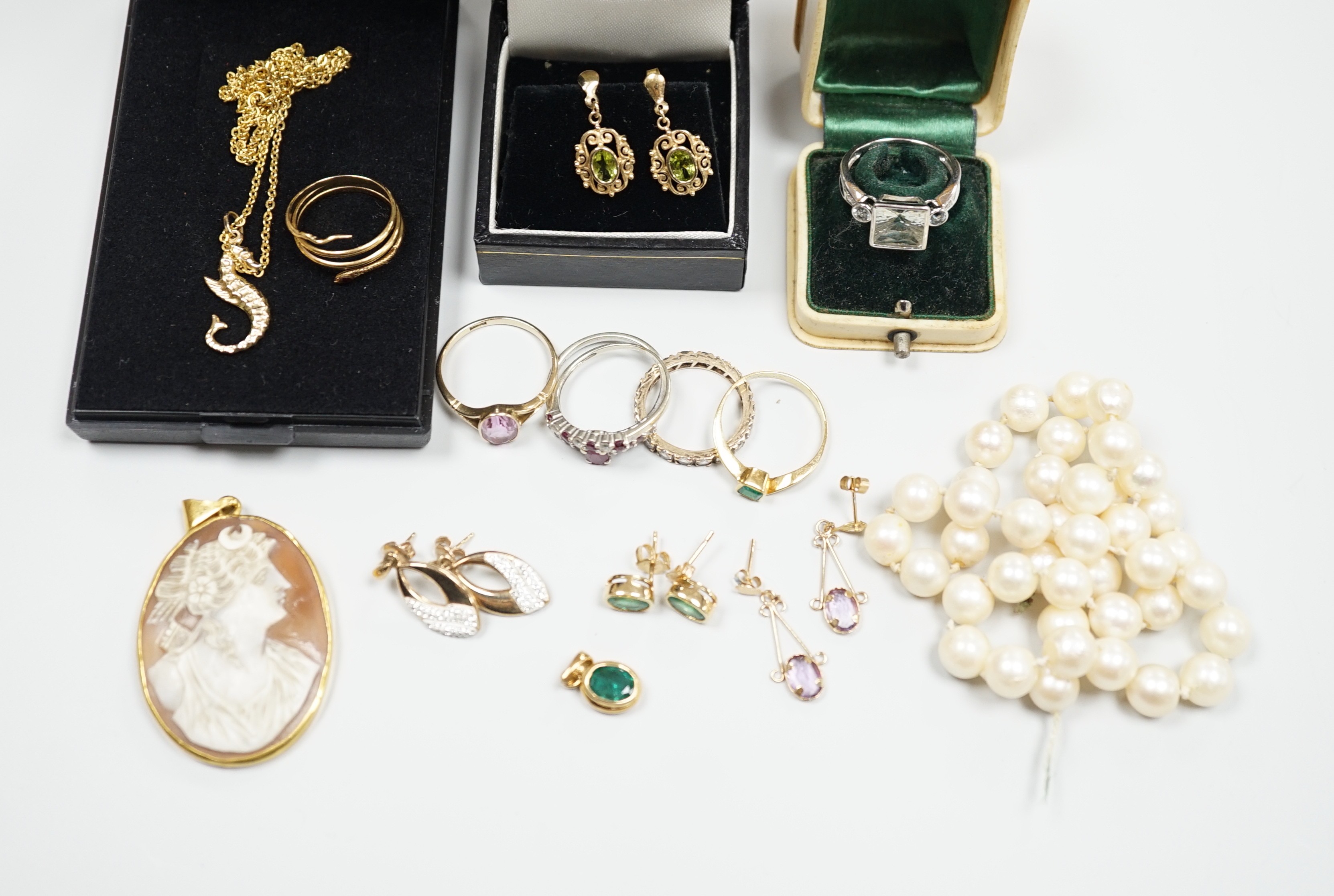 A small group of assorted modern jewellery including a 750 yellow metal and gem set serpent ring, gross 2.4 grams, a 15ct and gem set ring, gross 2.6 grams, a pair of 14k and gem set ear studs, gross 2.1 grams, a 585 sea